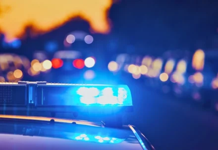Flashing blue emergency lights on top of a car.