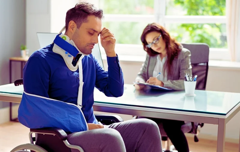 A man in a wheelchair with a neck brace.