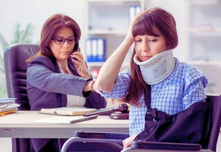 An injured woman in a wheelchair visits a lawyer.