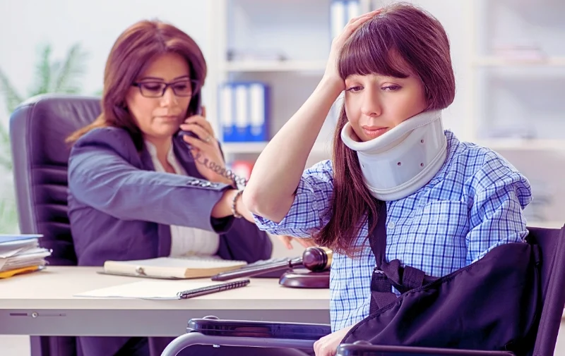 An injured woman in a wheelchair visits a lawyer.