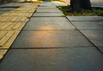 Close-up of gray stone tiles on a city sidewalk.