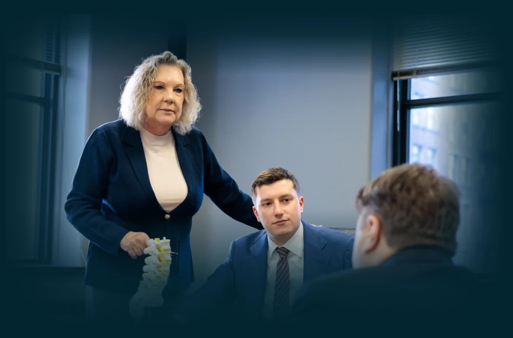 Chicago lawyers, John Serkland, Donna Zadeikis and Alexander Pino reviewing a spine model.